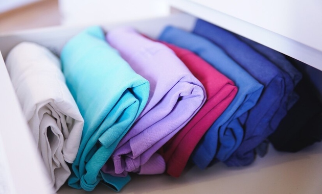 a pile of colored and non colored clothes 