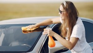 Girl cleaning car window