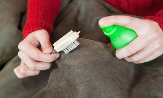 a man is cleaning couch stains with stain removing solution