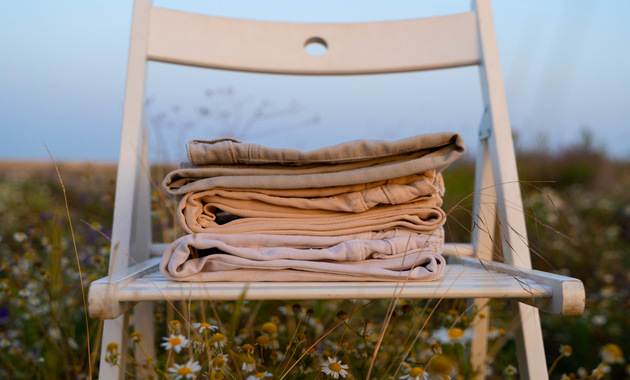 a pile of clothes on a chair